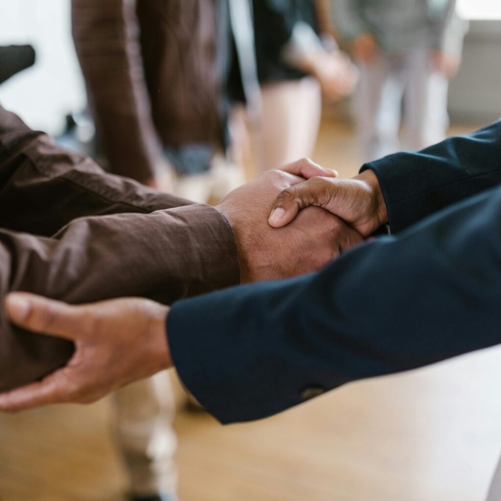 Close-up of two businesspeople shaking hands, symbolizing agreement and partnership.